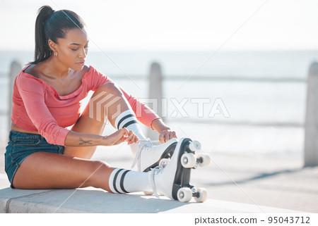 Fitness, exercise and happy woman roller skating along a beach on a sunny day, content while prepare for workout outdoors. Active female enjoying free time with hobby, exercising and cardio with fun 95043712