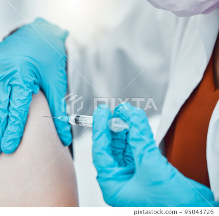 Medicine, healthcare and doctor doing a covid vaccine on a patient at hospital during pandemic. Closeup hands of a medical professional with gloves doing an antibody injection with syringe at clinic. 95043726
