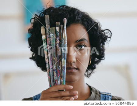 Brush, portrait and woman is a creative painter in an art gallery or workshop studio for watercolor painting. Freedom, artist and Indian girl with paintbrushes for her craft, hobby and drawing talent 95044099