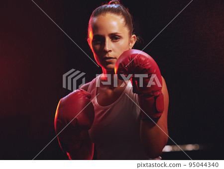 Fitness, boxer and woman in sports boxing gloves training, exercise and fighting to be a young champion fighter in the ring. Portrait, energy and strong girl with courage to power punch motivation Fitness, boxer and woman in sports boxing gloves training, exercise and fighting to be a young champion fighter in the ring. Portrait, energy and strong girl with courage to power punch motivation 95044340