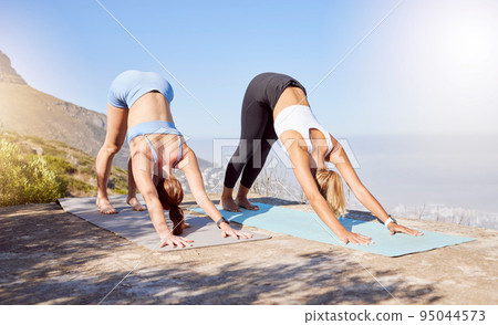 Yoga, women and stretching on mountains for relax fitness, exercise and training in South Africa. Friends, people and zen yogi in wellness body workout for mind peace, chakra energy and mental health Yoga, women and stretching on mountains for relax fitness, exercise and training in South Africa. Friends, people and zen yogi in wellness body workout for mind peace, chakra energy and mental health 95044573