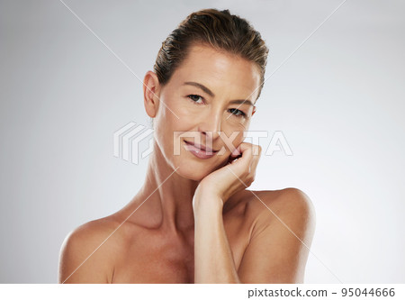 Mature woman, face and skincare routine for healthy glow on grey studio background with mockup space, healthcare wellness or collagen dermatology. Portrait, beauty model and hand on cheek with makeup 95044666