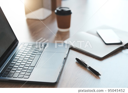 Empty desk, laptop and coffee shop with notebook, pc tech and pen for SEO, UX and UI web design at cafe store workspace. Desk or table with digital computer on internet wifi for online business email 95045452