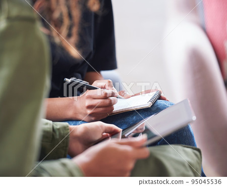 African american woman writing notes with friend showing ideas on digital tablet computer students brainstorming African american woman writing notes with friend showing ideas on digital tablet computer students brainstorming 95045536