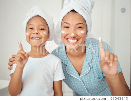 Skincare, grooming and portrait of mother and daughter smile, happy with hygiene treatment and face cream while bonding in bathroom. Cleaning, beauty and facial with excited girl and parent selfcare 95045545