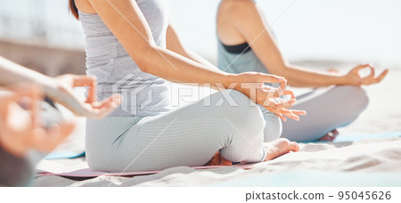 Women meditation in lotus with zen yoga class at the beach. Group of wellness female together on mat, leg crossed, finding inner mental balance and peace. Practice calming breathing exercise 95045626