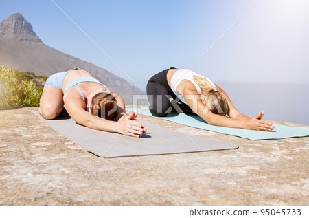 Women, yoga or zen workout on mountains in child pose for mental health, chakra energy or mind peace. Friends, people or relax fitness yogi stretching in body exercise, training or pilates meditation 95045733