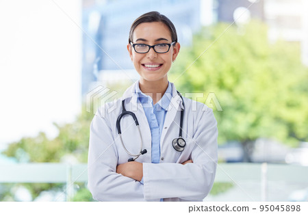 Healthcare, proud and doctor woman portrait with stethoscope in a hospital with bokeh and lens flare. Care, trust and mission of a young medical professional expert or worker with wellness motivation Healthcare, proud and doctor woman portrait with stethoscope in a hospital with bokeh and lens flare. Care, trust and mission of a young medical professional expert or worker with wellness motivation 95045898