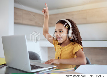 Child, laptop and smile with hand to answer question in class, education or study in home. Girl, computer and desk on video conference happy for education, communication or school on the internet 95045917