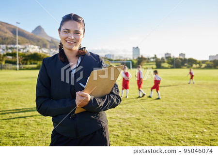 Football coach, junior sports and woman with clipboard coaching children on a soccer field or pitch outside on a sunny day. Happy female pe trainer outside for practice, training and exercise class 95046074