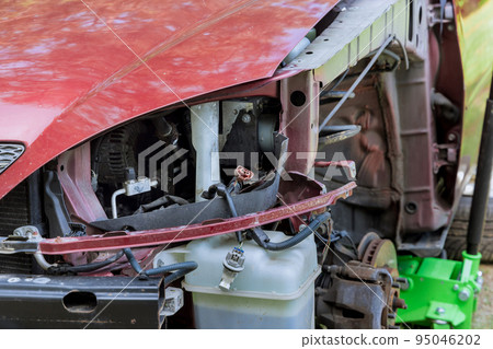 As a result of body damage sustained during an accident, the car is having its front fender replaced As a result of body damage sustained during an accident, the car is having its front fender replaced 95046202
