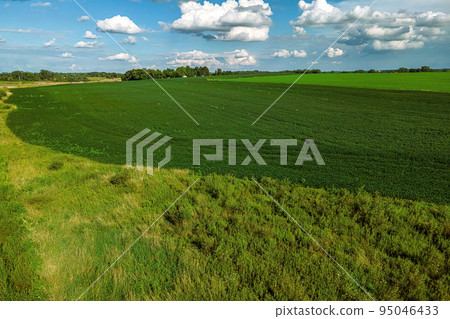 Tranquil scene overlooking summertime farm fields 95046433