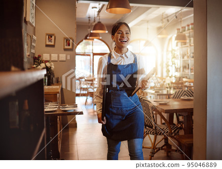 Woman, happy and waitress in restaurant working in apron with food menu in hand for table. Girl, smile and service work at luxury diner, cafe or coffee shop show happiness on face for job in London 95046889