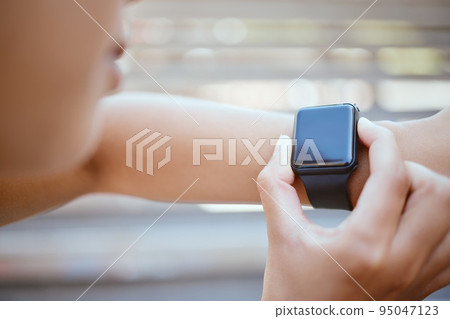 Fitness, woman and hands for time on watch checking or monitoring health after exercise training workout outdoor. Hand of female with smartwatch monitor check and time in healthy run or cardio sports 95047123