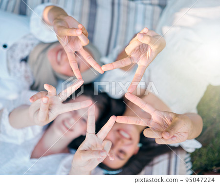 Peace, friends and hand sign while happy women bond, have fun and support each other while on a picnic at a park in nature. Above view, flare and star gesture with diversity females enjoying freedom Peace, friends and hand sign while happy women bond, have fun and support each other while on a picnic at a park in nature. Above view, flare and star gesture with diversity females enjoying freedom 95047224