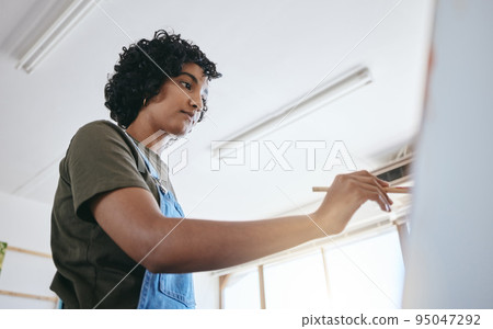 Paint, art and creative with a woman painter painting on a canvas in an artwork studio or workshop for artistic expression. Creative, inspiration and skill with an artsy female working in a gallery 95047292