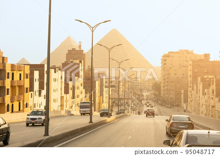 Cairo street with pyramids in the background 95048717