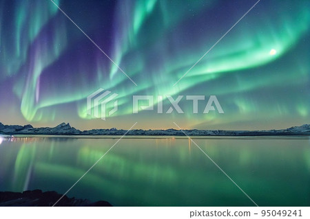 Northern lights reflected in water, aurora borealis over sea surface Northern lights reflected in water, aurora borealis over sea surface 95049241