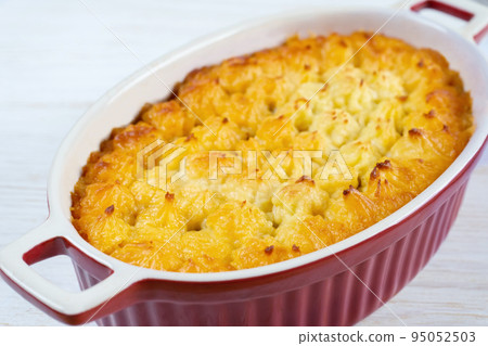 Shepherd's Pie or Cottage Pie, traditional British dish on white wooden background Shepherd's Pie or Cottage Pie, traditional British dish on white wooden background 95052503
