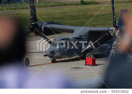 U.S. military aircraft V-22 Osprey and onlookers during maintenance U.S. military aircraft V-22 Osprey and onlookers during maintenance 95053602