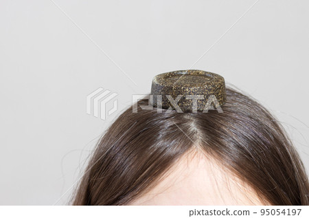 A woman and a solid shampoo with natural makeup. Eco-friendly soap without plastic and pollution 95054197