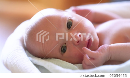 newborn. baby newborn a close-up lies looking at the camera lifestyle in the hospital maternity hospital. happy family baby dream concept. cute newborn baby wrapped in a blanket newborn. baby newborn a close-up lies looking at the camera lifestyle in the hospital maternity hospital. happy family baby dream concept. cute newborn baby wrapped in a blanket 95054453