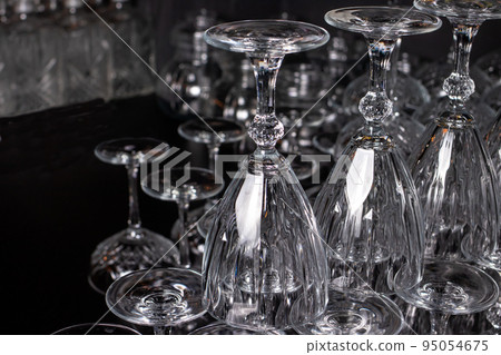 Lots of empty glass glasses for alcohol. Glass upside down. Lots of empty glass glasses for alcohol. Glass upside down. 95054675