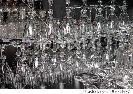 Lots of empty glass glasses for alcohol. Glass upside down. Lots of empty glass glasses for alcohol. Glass upside down. 95054677