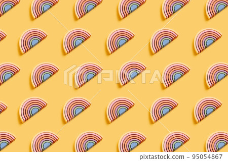 Education kid arch toy , pastel pyramid game on pink background. Colorful wooden figure on yellow background, kid play concept Education kid arch toy , pastel pyramid game on pink background. Colorful wooden figure on yellow background, kid play concept 95054867
