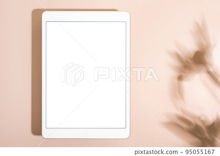 Blank screen tablet mock up and shadow on green pastel background. Copy space. Mock up template. Business communication. Isolated object. Spring decoration. 95055167