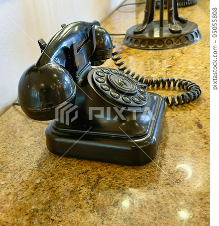 Antique retro telephone on a table with a marble top. Antique retro telephone on a table with a marble top. 95055808