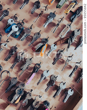 Key box cabinet or locker key for storage with many keychains and track colors hanging inside. 95055842