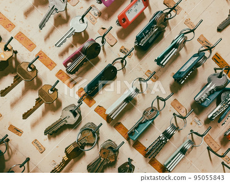 Key box cabinet or locker key for storage with many keychains and track colors hanging inside. 95055843