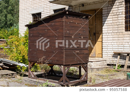 Wooden hive in the yard of the house Wooden hive in the yard of the house 95057588