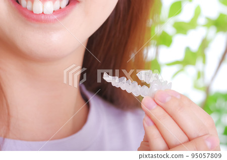 Young woman with dental mouthpiece 95057809