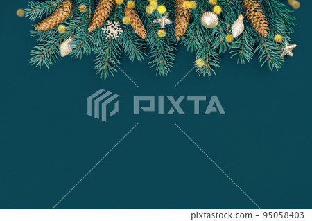 Merry Christmas and Happy New Year rich golden and crystal baubles festive ornaments garland. Top border with lights. Christmas tree branches with cones on teal green. Party decor banner. Top view Merry Christmas and Happy New Year rich golden and crystal baubles festive ornaments garland. Top border with lights. Christmas tree branches with cones on teal green. Party decor banner. Top view 95058403