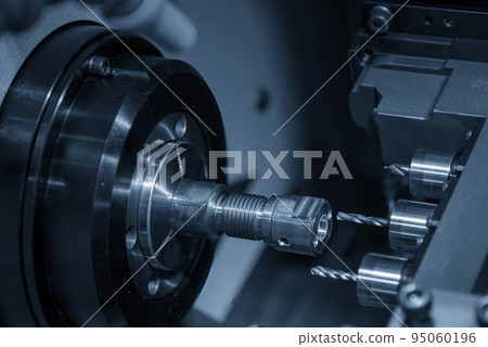 The multi-tasking CNC lathe machine swiss type drilling the brass shaft parts. The multi-tasking CNC lathe machine swiss type drilling the brass shaft parts. 95060196