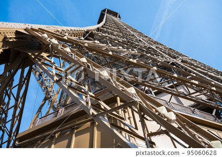 Eiffel tower close up. Angled view while climbing to the second froor of the landmark, selective focus Eiffel tower close up. Angled view while climbing to the second froor of the landmark, selective focus 95060628
