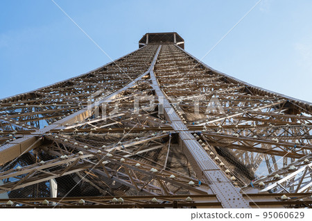 Eiffel tower close up. Angled view while climbing to the second froor of the landmark, selective focus Eiffel tower close up. Angled view while climbing to the second froor of the landmark, selective focus 95060629