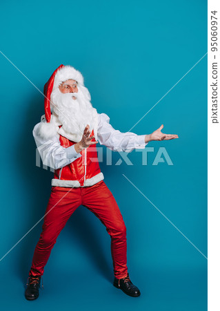 Full size photo of santa claus who gesturing hands pointing to ad text. New Year advertisement 95060974