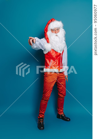full size of Santa Claus pointing index finger aside isolated on blue background. New Year mock up 95060977