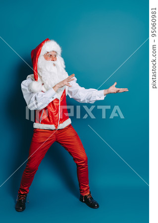 Full size of stylish santa claus who gesturing hands pointing to ad text. New Year advertisement Full size of stylish santa claus who gesturing hands pointing to ad text. New Year advertisement 95060981