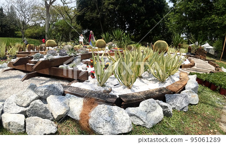 JOHOR, MALAYSIA -MAY 3, 2022: Flower and shrub planter boxes are built in public parks. Exposed to the weather and only hardy plants are planted here. 95061289