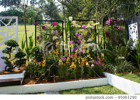 JOHOR, MALAYSIA -MAY 3, 2022: Flower and shrub planter boxes are built in public parks. Exposed to the weather and only hardy plants are planted here. JOHOR, MALAYSIA -MAY 3, 2022: Flower and shrub planter boxes are built in public parks. Exposed to the weather and only hardy plants are planted here. 95061290