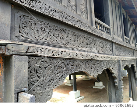 NEGERI SEMBILAN, MALAYSIA - APRIL 4, 2022: Handmade carvings in a traditional Malay house in Negeri Sembilan, Malaysia. This carving is made on selected wood to give the best results. 95061692
