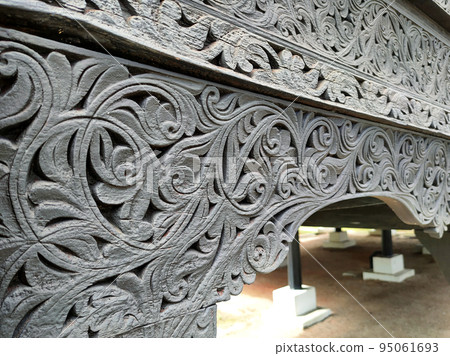 NEGERI SEMBILAN, MALAYSIA - APRIL 4, 2022: Handmade carvings in a traditional Malay house in Negeri Sembilan, Malaysia. This carving is made on selected wood to give the best results. 95061693