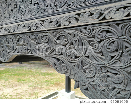 NEGERI SEMBILAN, MALAYSIA - APRIL 4, 2022: Handmade carvings in a traditional Malay house in Negeri Sembilan, Malaysia. This carving is made on selected wood to give the best results. 95061696
