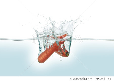 Two carrots splashing in water. Two carrots splashing in water. 95061955