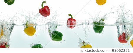 Many multi colored peppers splashing in water. Many multi colored peppers splashing in water. 95062231