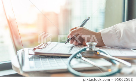 Telehealth, telemedicine medical service and online health care concept with doctor giving medical prescription, analyzing patient health in hospital working on computer laptop Telehealth, telemedicine medical service and online health care concept with doctor giving medical prescription, analyzing patient health in hospital working on computer laptop 95062598